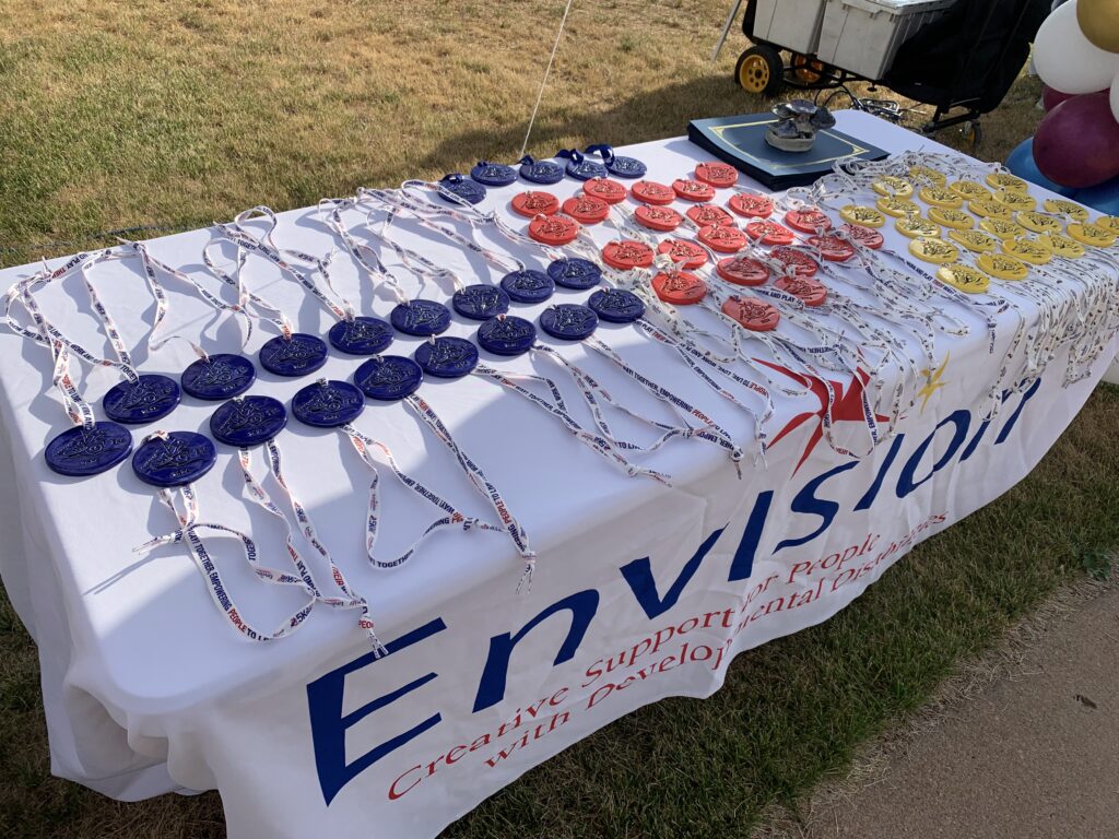 Close up of the first through third place medals hand made by the artists of Envision and the Clay Center